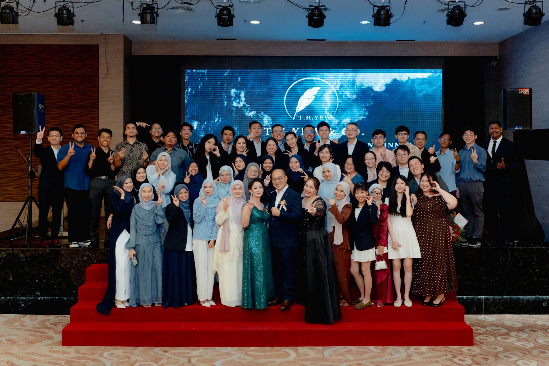 30th Anniversary Dinner — full team group photo on stage